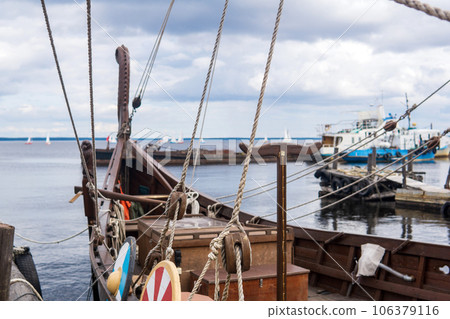 fragment of the rigging of a wooden old sailing ship close-up fragment of the rigging of a wooden old sailing ship close-up 106379116
