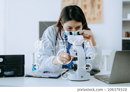 Female scientist researcher conducting an experiment working in the chemical laboratory with VR icons 106379328