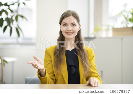 A smiling foreign woman talking while looking at the camera 106379337