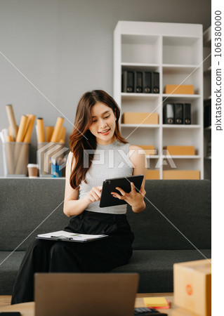 Fashion blogger concept, Young Asian women selling clothes on video streaming.Startup small business SME, using smartphone or tablet taking receive and checking. 106380000