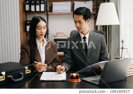 Asian business team and lawyers discussing contract papers sitting at the table. Concepts of law, advice, legal services. at modern office Asian business team and lawyers discussing contract papers sitting at the table. Concepts of law, advice, legal services. at modern office 106380957