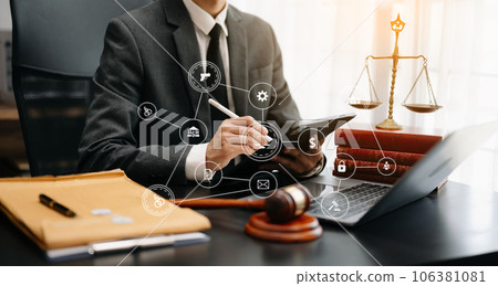 justice and law concept.Male judge in a courtroom the gavel, working with smart phone and laptop and digital tablet computer on wood table justice and law concept.Male judge in a courtroom the gavel, working with smart phone and laptop and digital tablet computer on wood table 106381081