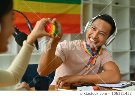 Male and female hands holding rainbow heart with smiling face. LGBTQ, human rights and equality social Male and female hands holding rainbow heart with smiling face. LGBTQ, human rights and equality social 106381432