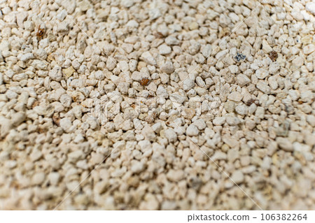 Bentonite clumping clay litter for cat litter box and pets close-up. 106382264