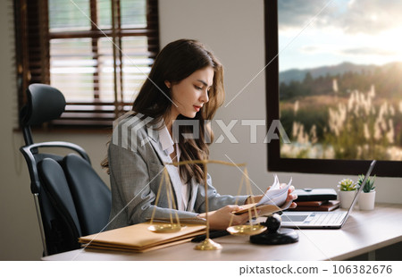 Asian woman lawyer working and gavel, tablet, laptop in front, Advice justice and law concept.. Asian woman lawyer working and gavel, tablet, laptop in front, Advice justice and law concept.. 106382676