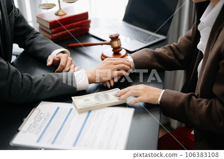 Business people compassionately holding hands and discussing contract papers with laptop and tabletat office .. Business people compassionately holding hands and discussing contract papers with laptop and tabletat office .. 106383108