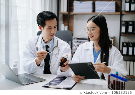 Medical technology network team meeting concept. Asian Doctor hand working with smart phone modern digital tablet and laptop computer with graphics chart interface, Medical technology network team meeting concept. Asian Doctor hand working with smart phone modern digital tablet and laptop computer with graphics chart interface, 106383156