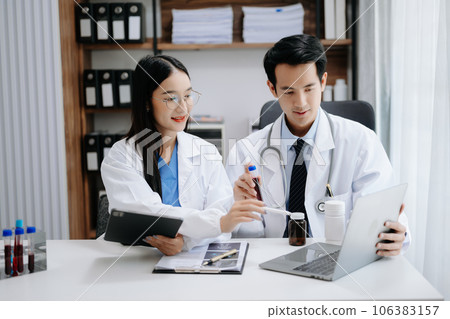 Medical technology network team meeting concept. Asian Doctor hand working with smart phone modern digital tablet and laptop computer with graphics chart interface, Medical technology network team meeting concept. Asian Doctor hand working with smart phone modern digital tablet and laptop computer with graphics chart interface, 106383157