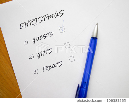 Checklist of new year holidays, text on a white sheet of paper next to a blue pen. 106383265