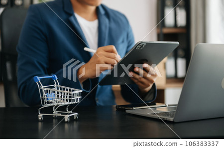 businesswoman hand using smart phone, tablet payments and holding credit card online shopping, omni channel, digital tablet docking keyboard computer i. 106383337