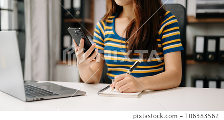 businesswoman hand working with new modern computer and writing on the notepad strategy diagram as concept . businesswoman hand working with new modern computer and writing on the notepad strategy diagram as concept . 106383562