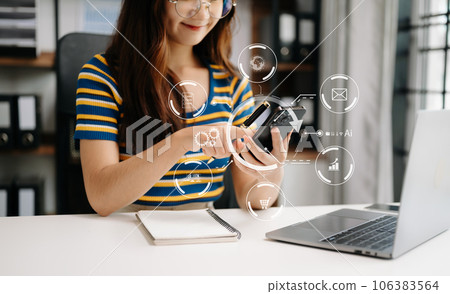Digital marketing media in virtual screen.businesswoman hand working with mobile phone and modern compute with VR icon diagram at office 106383564