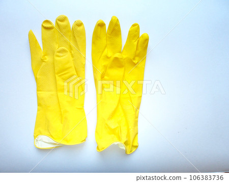 Photo of bright rubber gloves on a light background with an empty space for text. Housework and maintenance of cleanliness is the main concept of maintenance. Photo of bright rubber gloves on a light background with an empty space for text. Housework and maintenance of cleanliness is the main concept of maintenance. 106383736