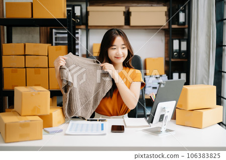 Fashion blogger concept, Young Asian women selling clothes on video streaming.Startup small business SME, using smartphone or tablet taking receive and checking. 106383825