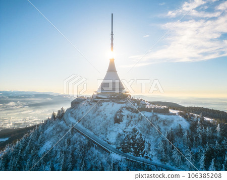 Jested mountain with modern hotel and TV transmitter on the top, Liberec, Czech Republic. Sunny winter day with snowy landscape. Aerial view from drone. 106385208