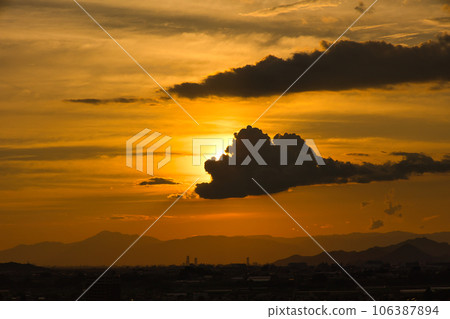 Beautiful orange sunset sky with clouds 106387894