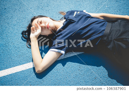 Midsummer athletics stadium and young woman in a polo shirt Midsummer athletics stadium and young woman in a polo shirt 106387901