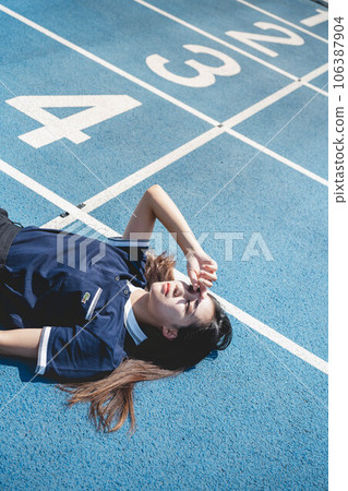 Midsummer athletics stadium and young woman in a polo shirt Midsummer athletics stadium and young woman in a polo shirt 106387904