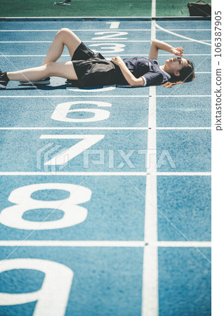 Midsummer athletics stadium and young woman in a polo shirt Midsummer athletics stadium and young woman in a polo shirt 106387905