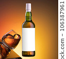 Bottle of whiskey on an orange background, glass with ice on glass, in the air 106387961