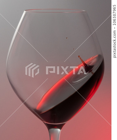 A falling drop of red wine in a glass, close-up. A falling drop of red wine in a glass, close-up. 106387965