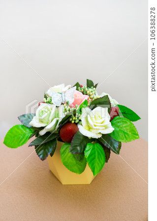 Bouquet of fragrant flowers from handmade soap in a wicker basket on a white background Bouquet of fragrant flowers from handmade soap in a wicker basket on a white background 106388278