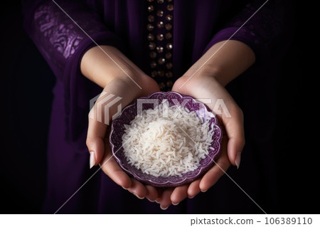 Female hands holding a bowl of rice Female hands holding a bowl of rice 106389110