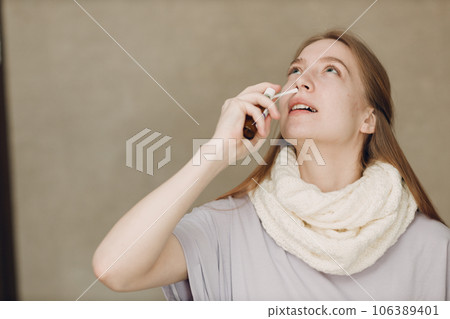 Young woman has flu catarrh ill sick disease treatment cold hold medicine nasal spray Young woman has flu catarrh ill sick disease treatment cold hold medicine nasal spray 106389401