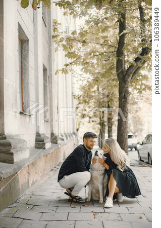 Man and woman happy together. Urban setting, husky dog. 106389449