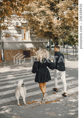 Man and woman happy together. Urban setting, husky dog. 106389450