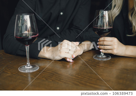 Man and woman relax, couple hugs in bar. Drinking wine. Man and woman relax, couple hugs in bar. Drinking wine. 106389473