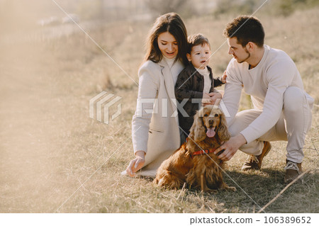 Family with cute little son. People in a summer field. Family with cute dog. 106389652