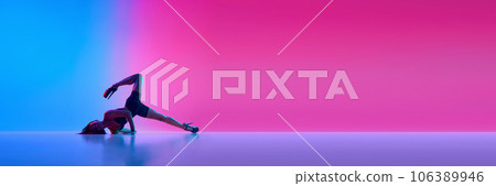 Banner. Young beautiful fit woman dancer posing on floor in the style of synch wave in blue-pink gradient neon light. 106389946