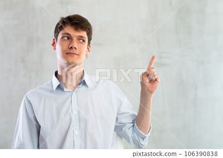 Positive man pointing with his hand at something - advertising concept 106390838