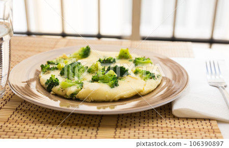 Wholesome breakfast. omelet with broccoli on brown plate Wholesome breakfast. omelet with broccoli on brown plate 106390897