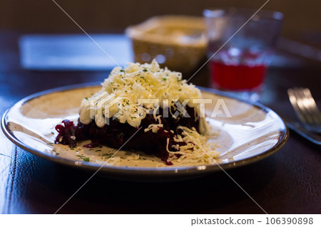 Mix of beets, cheese, mayonnaise on a plate in restaurant Mix of beets, cheese, mayonnaise on a plate in restaurant 106390898