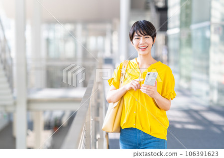 A young woman operating a smartphone. A young woman operating a smartphone. 106391623