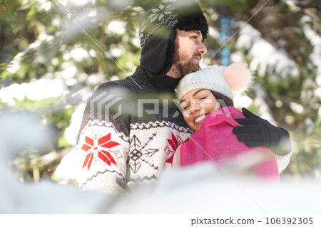 Couple spending quality time with each other in winter forest Couple spending quality time with each other in winter forest 106392305