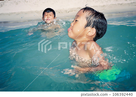 A boy swimming in the sea and enjoying the beautiful waves of the sea 106392440