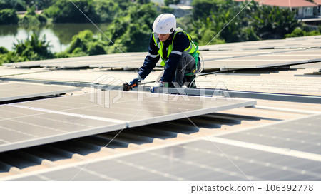 Engineers with safety helmet checking solar system at solar power farm 106392778