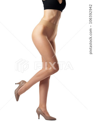 Legs of slim woman in tights on white background 106392942