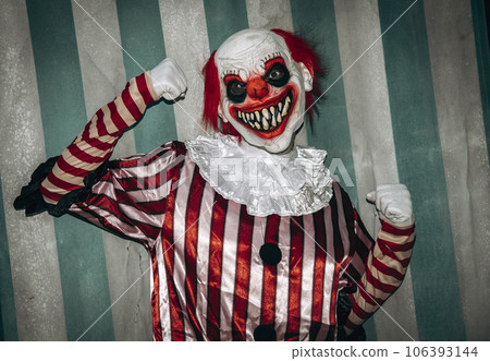 evil clown in the circus posing as the muscleman 106393144