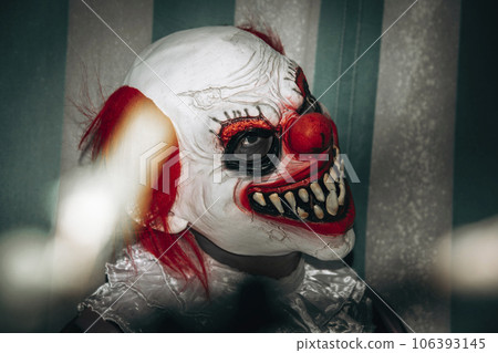 evil redhead clown smiles creepily in the circus 106393145