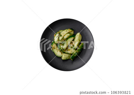Delicious juicy cucumber cut into large slices with salt, spices and french mustard Delicious juicy cucumber cut into large slices with salt, spices and french mustard 106393821