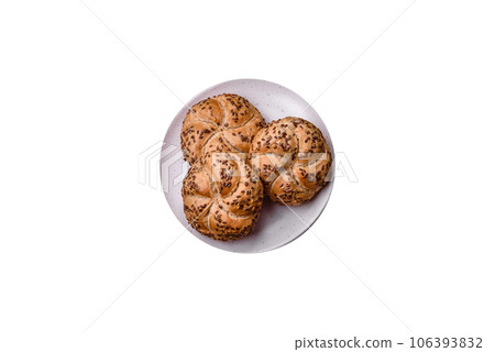Delicious freshly baked crispy bun or kaiser roll with sesame seeds 106393832