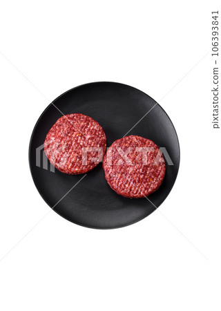 Fresh raw ground beef burger patty with salt and spices Fresh raw ground beef burger patty with salt and spices 106393841