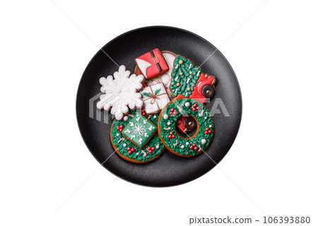 Delicious fresh colorful Christmas or New Year gingerbread cookies Delicious fresh colorful Christmas or New Year gingerbread cookies 106393880