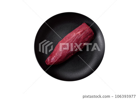Juicy raw beef with spices, salt and herbs on a dark concrete background 106393977