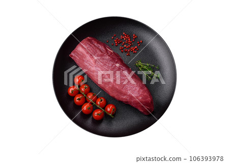 Juicy raw beef with spices, salt and herbs on a dark concrete background 106393978