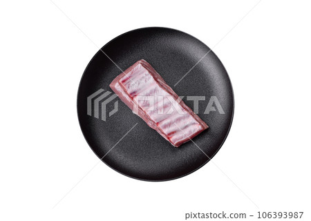 Raw pork ribs with meat with salt, spices and herbs 106393987